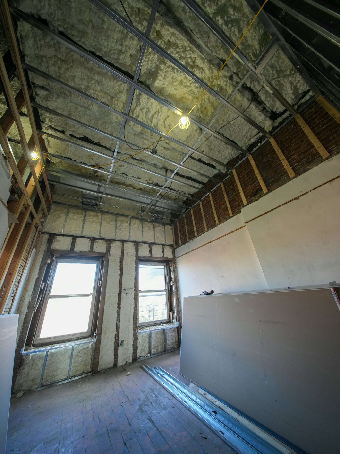 Room with insulated ceiling and drywall sheets ready to hang